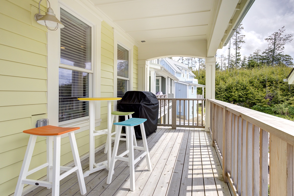 The covered back deck has a BBQ and seating