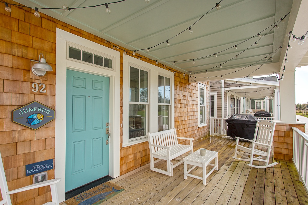 Covered porch with outdoor seating and bbq