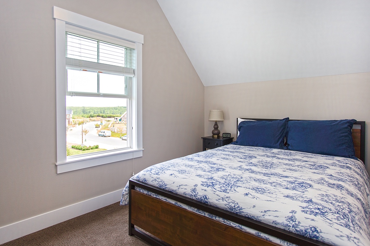 Third floor guest bedroom with queen bed and view of Horseshoe Park