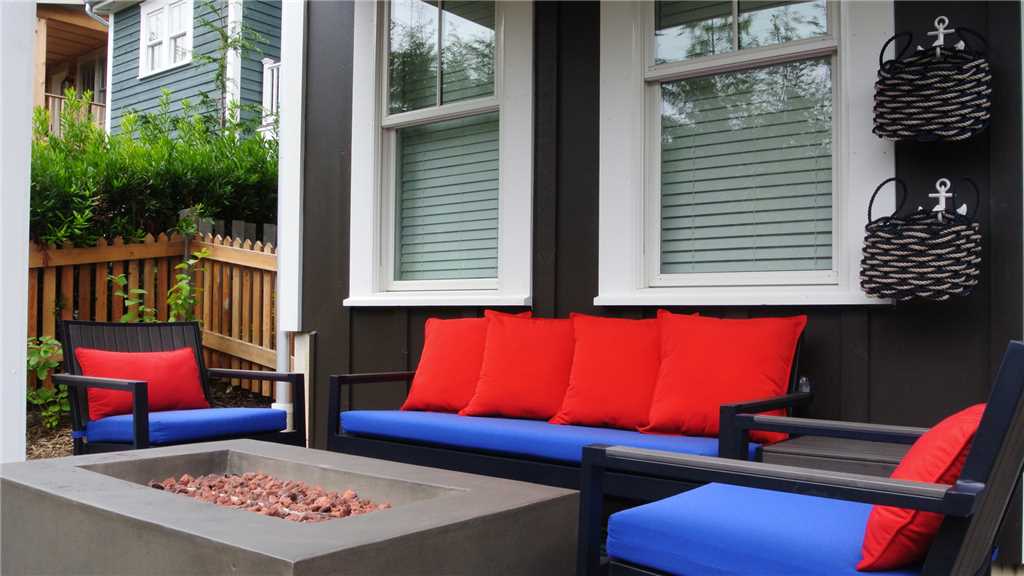 Outdoor furniture and propane fire table on back patio
