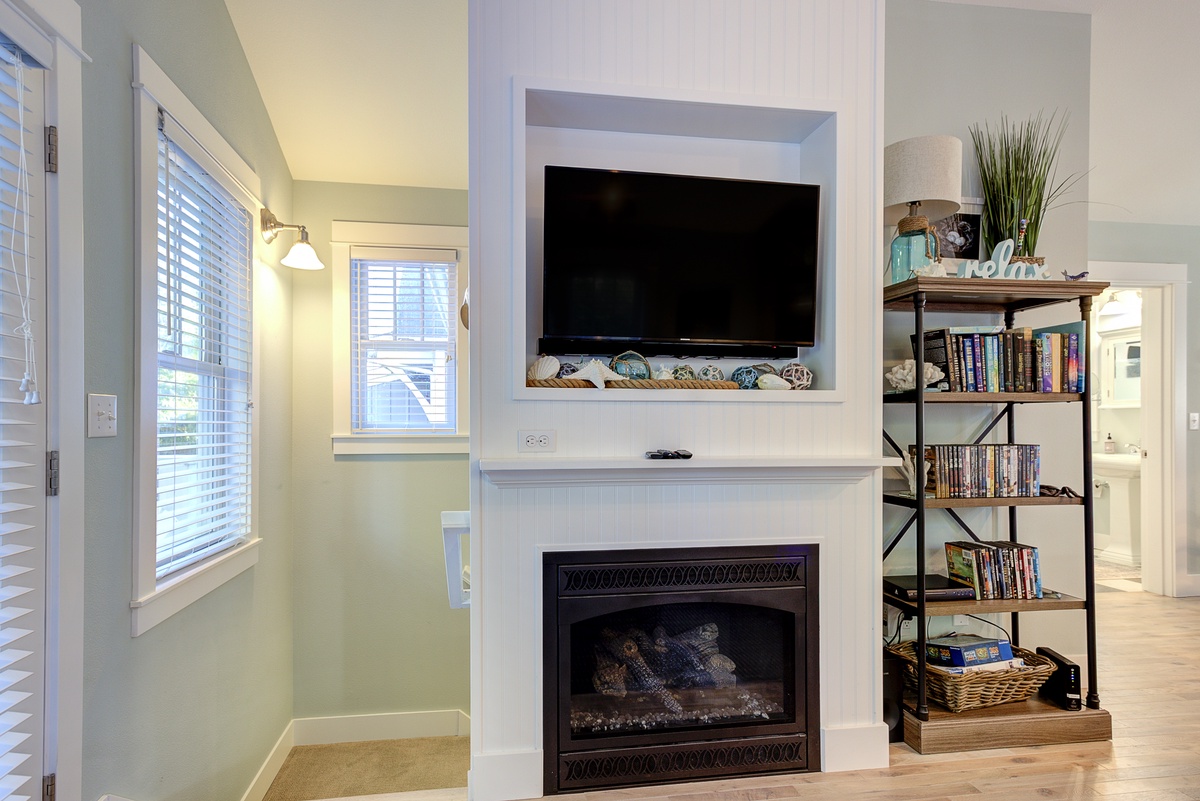 Cozy up by the warm glow of the fireplace while watching your favorite shows
