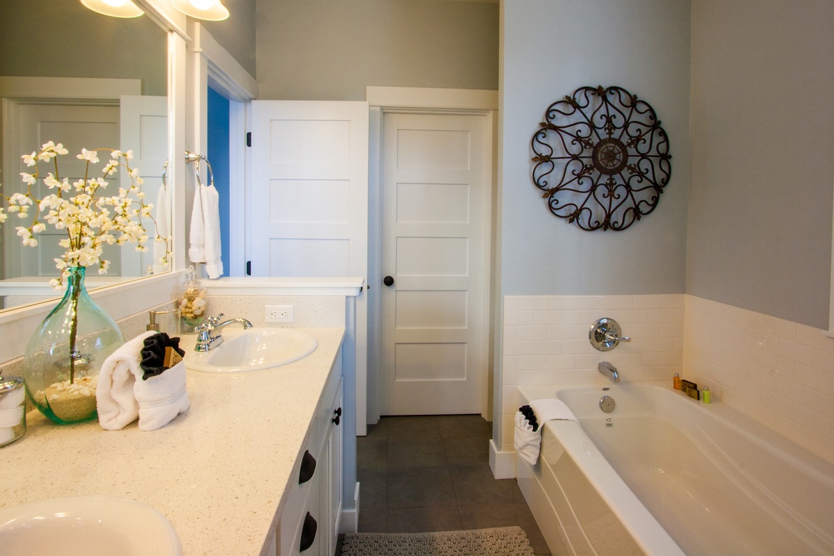 Primary ensuite bathroom with soaking tub, shower and walk in closet