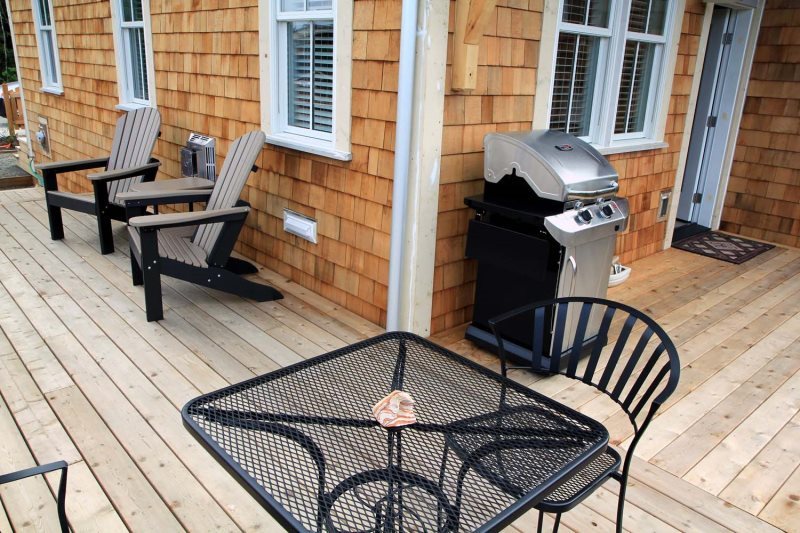 Adirondack chairs on the wrap around deck, gas grill 