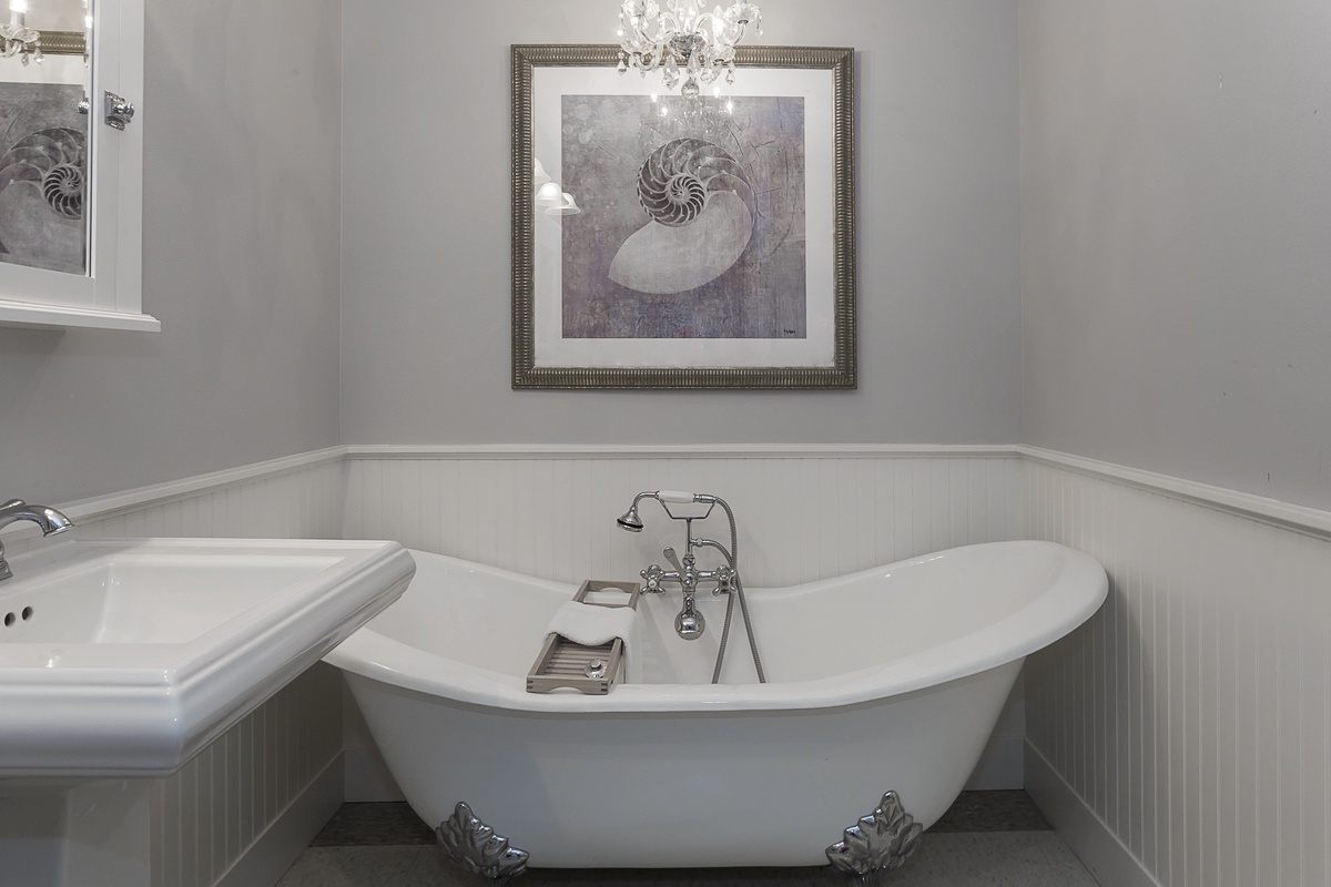 Private bathroom with his and hers vanity, large Clawfoot soaking tub and separate shower