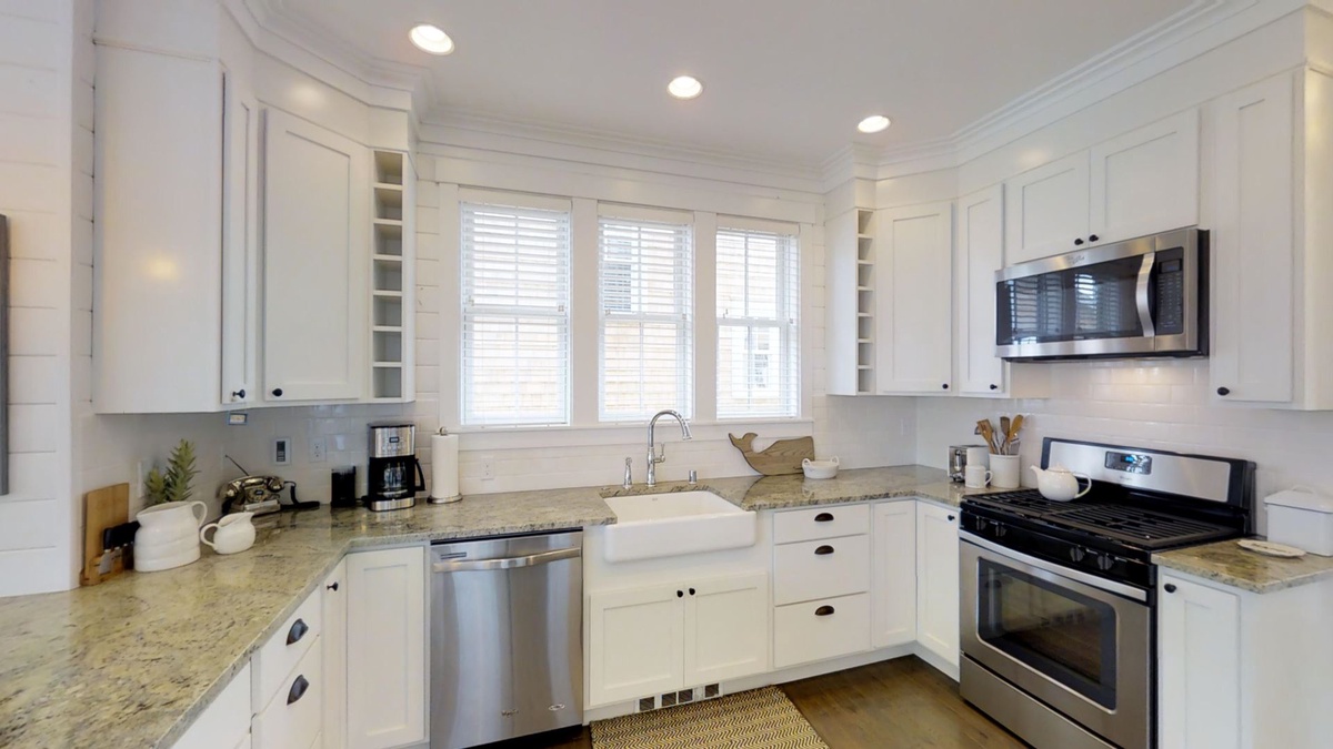 Stainless steal appliances and granite countertops on beautiful white cabinetry