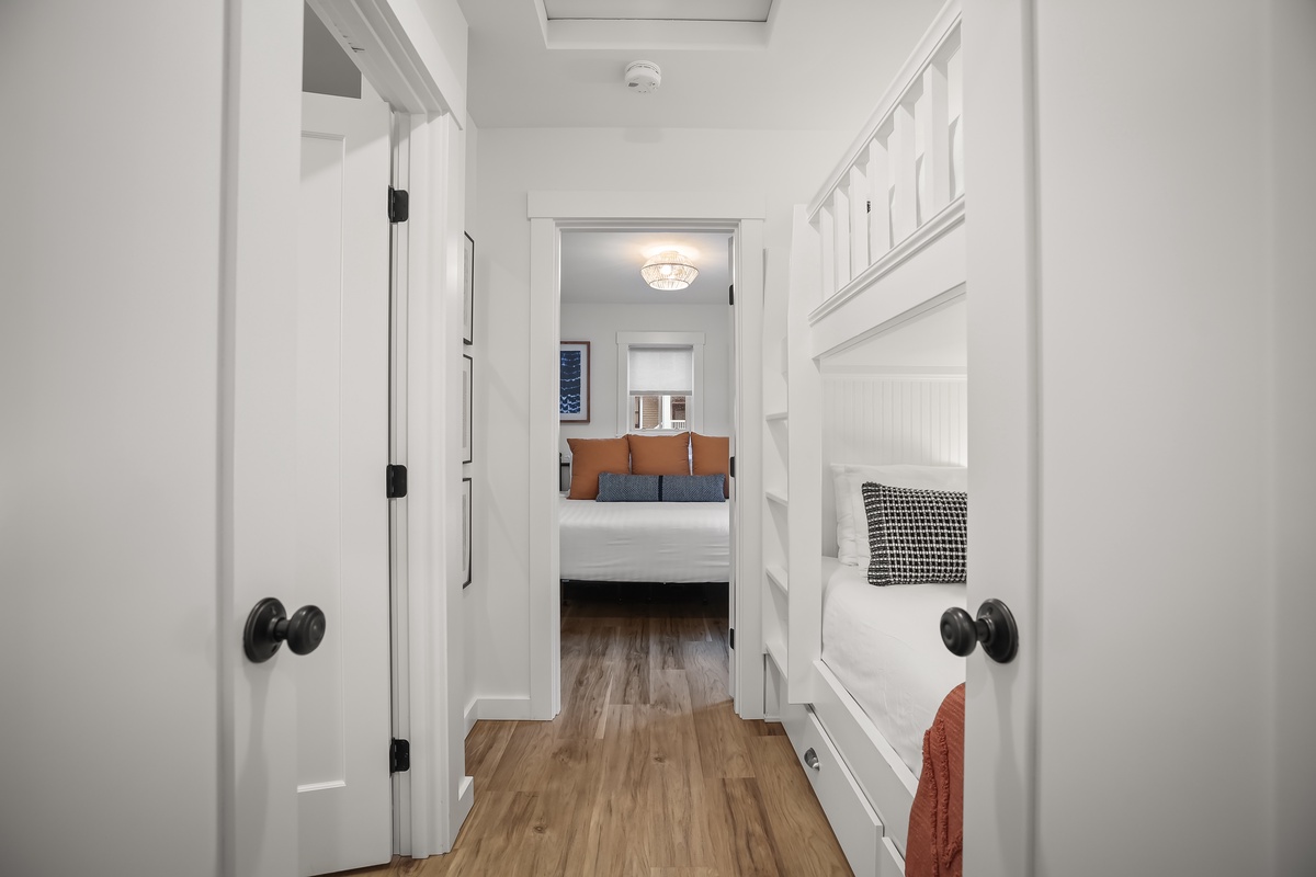 Doors reveal bunks and the primary bedroom