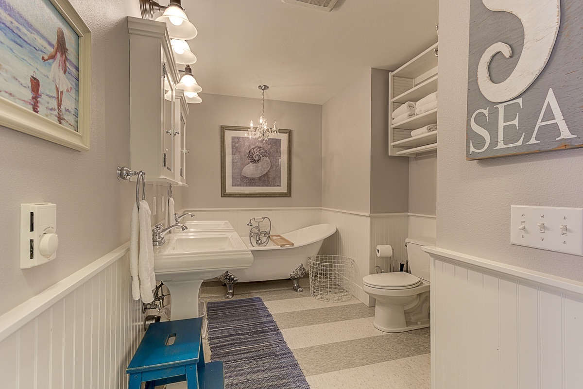 Private bathroom with his and hers vanity, large Clawfoot soaking tub and separate shower