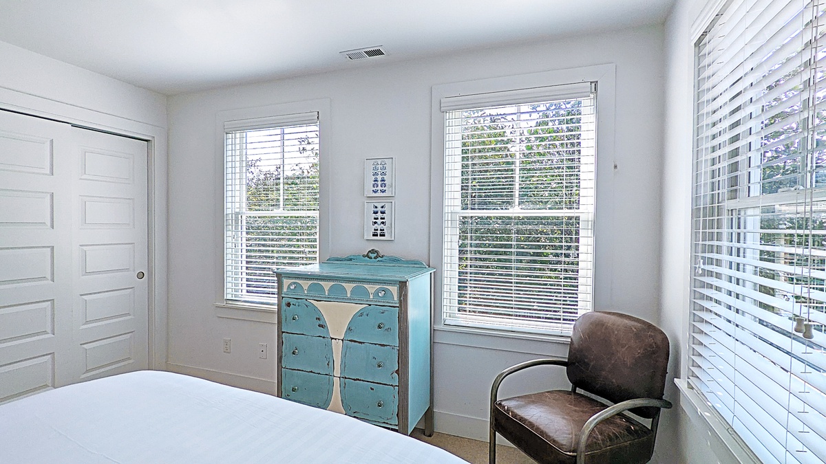 The bedroom has lots of natural light