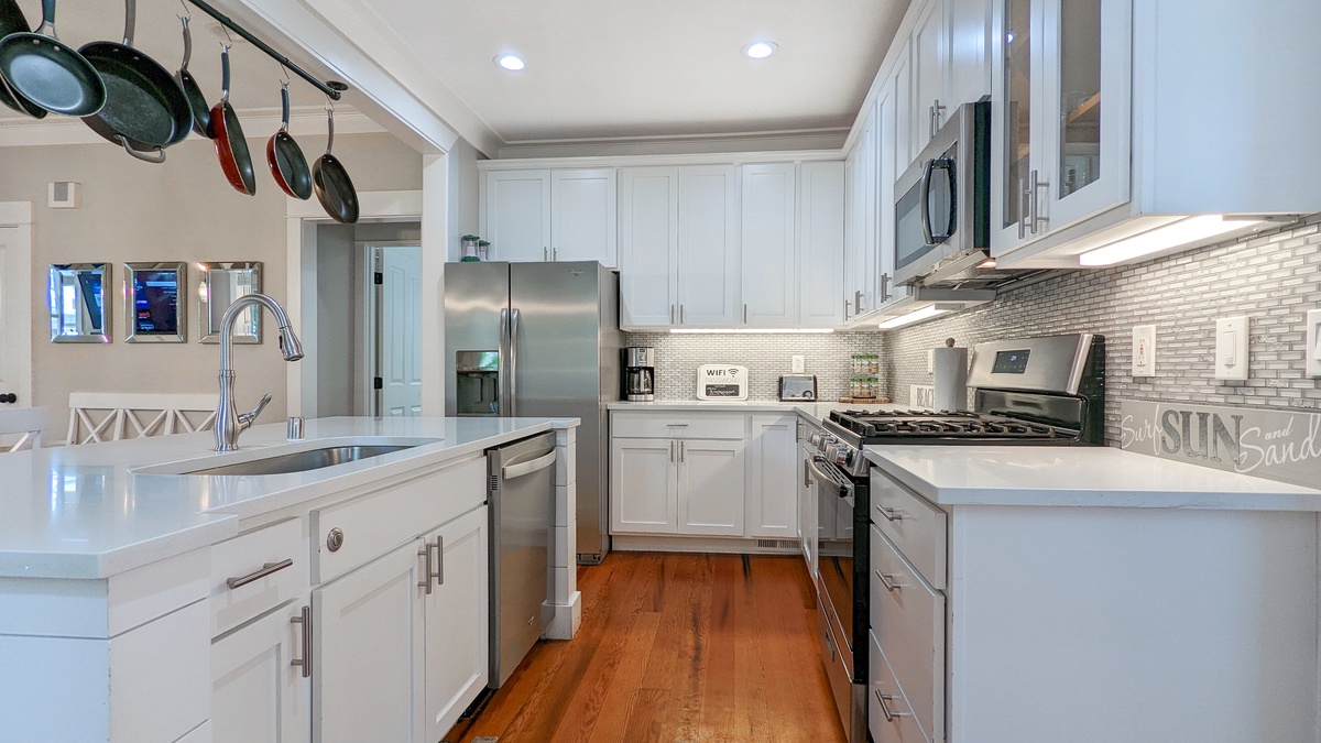 The well-stocked kitchen has a gas range