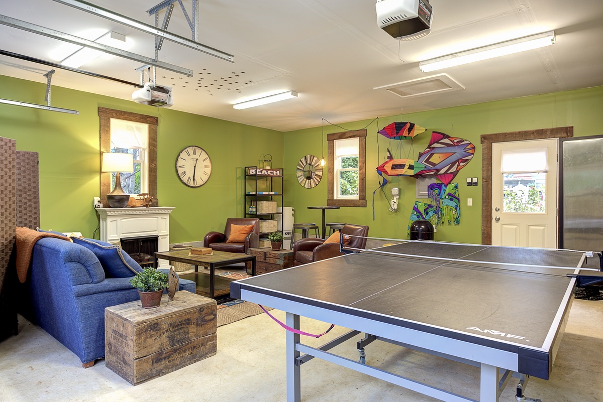 garage with ping pong table and dart board