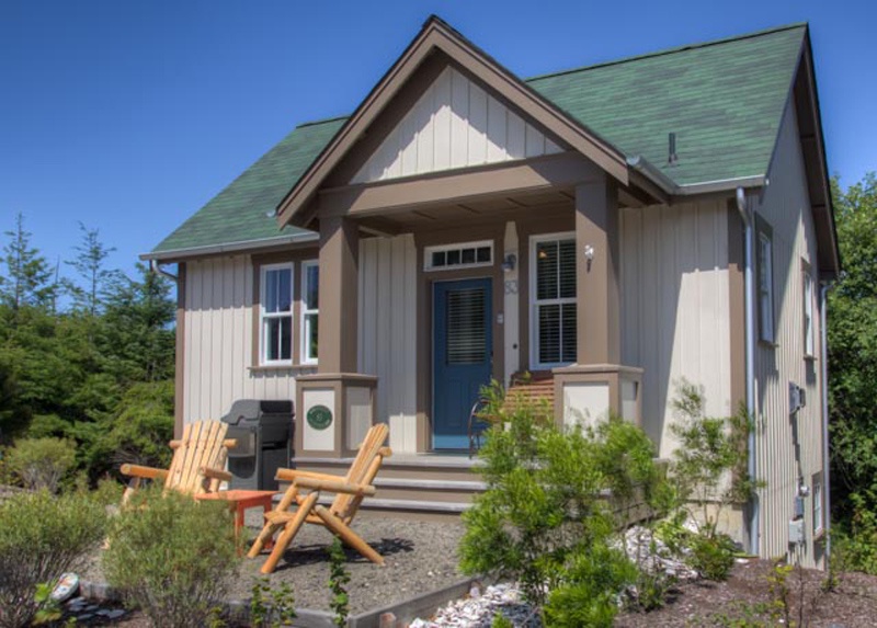 Front yard with Adirondack chairs for sunbathing and a gas BBQ