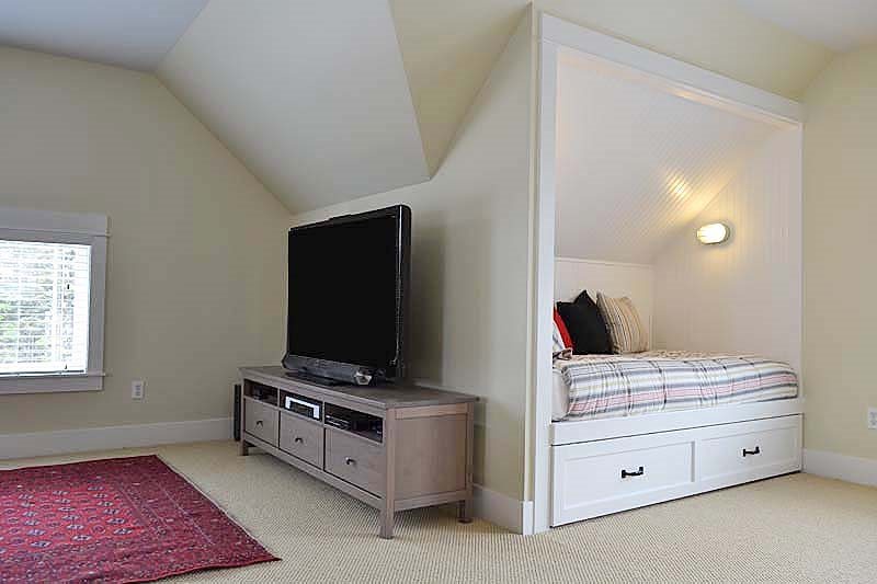 The third floor media center adjacent to built-in daybeds, prefect for kids