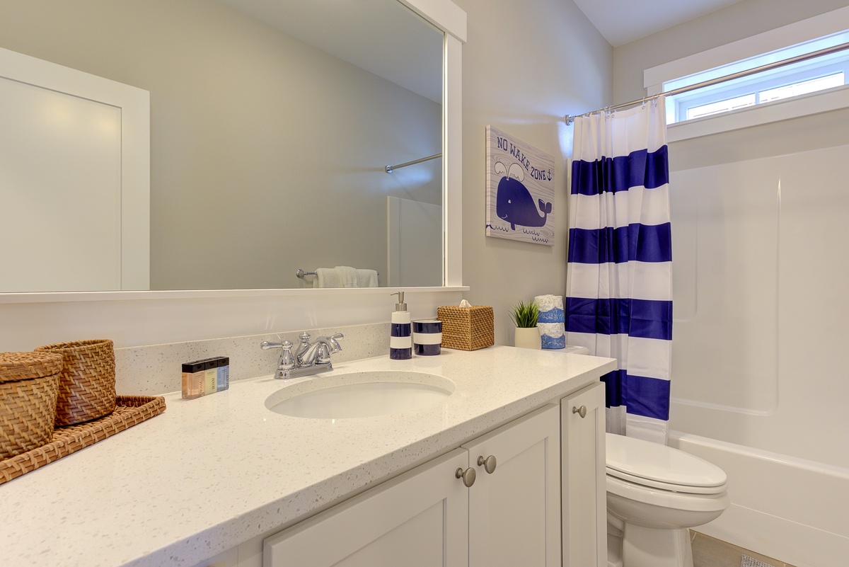 Full guest bathroom downstairs offers a spa-like retreat