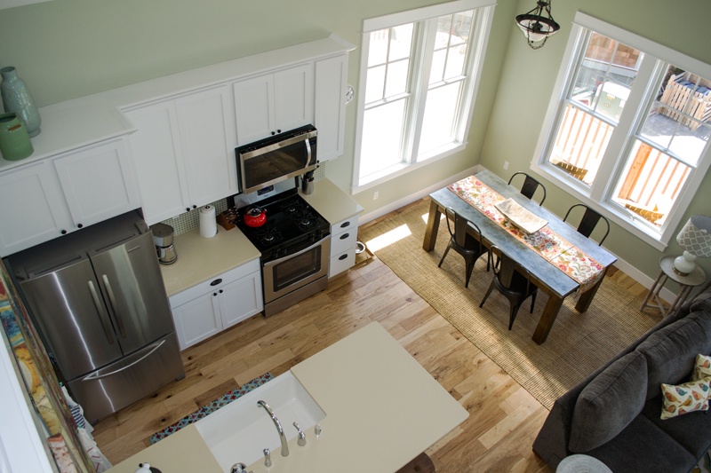 View looking down to the kitchen and dining room from the loft bedroom