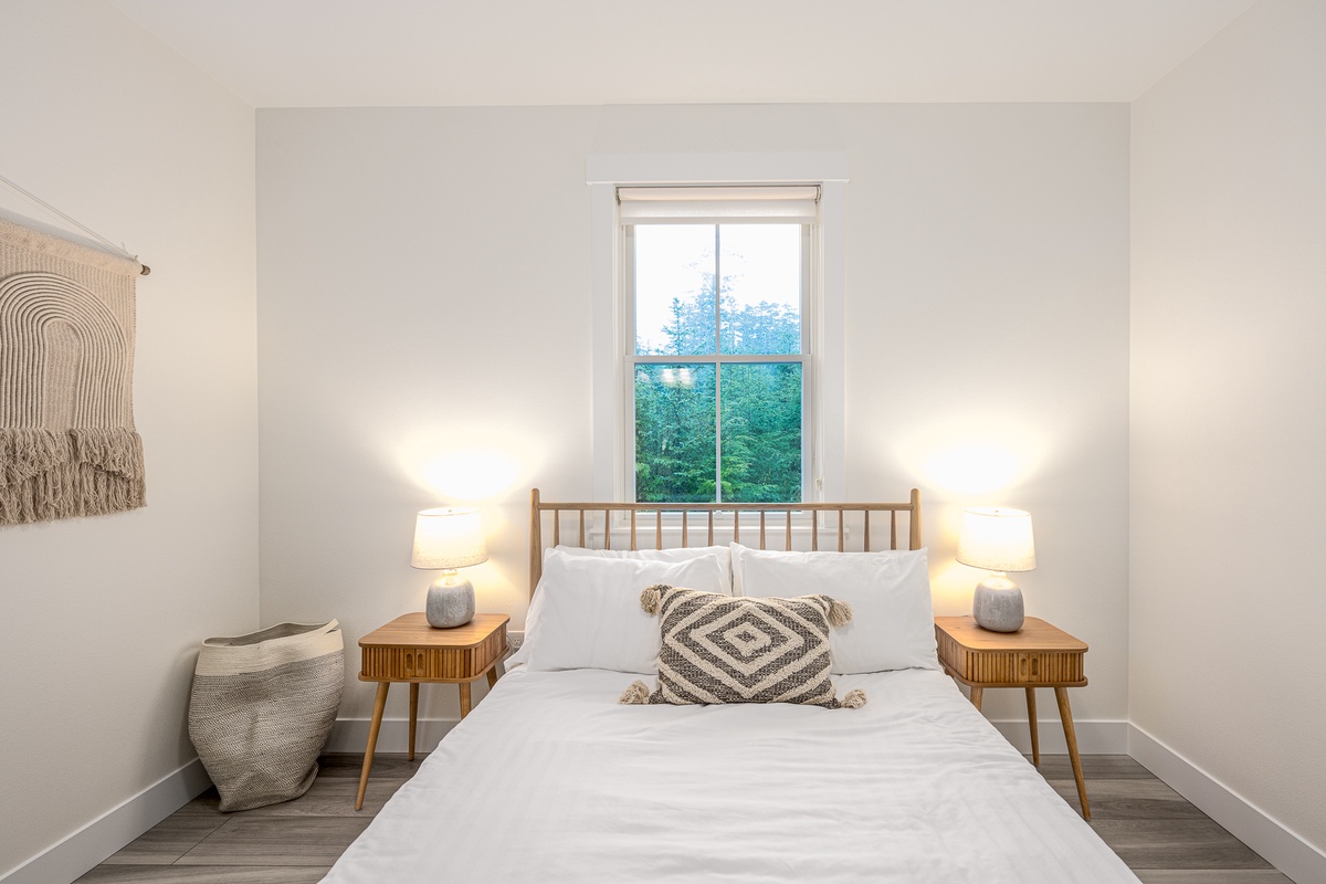 Wake up to tranquil forest views from the queen guest bedroom