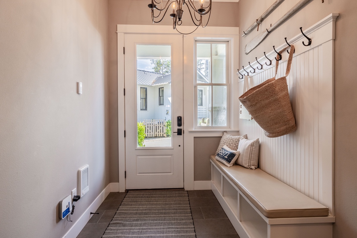 Mudroom features hooks and a bench for all your stuff