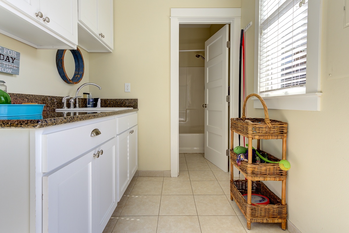 The spacious mudroom leads to the backyard