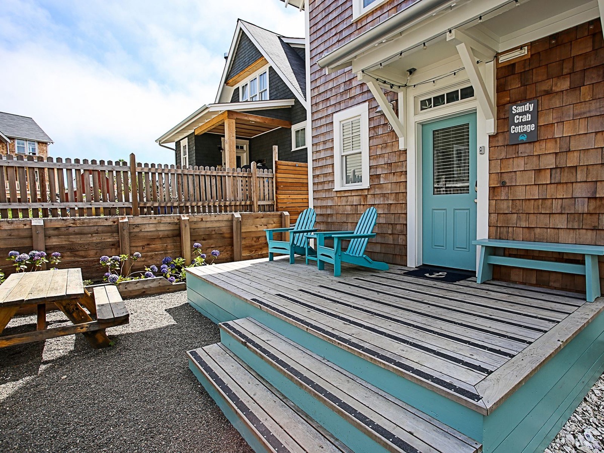 Front entry with adirondack chairs and picnic table