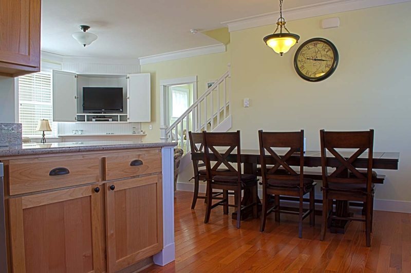 Sturdy wood trestle table in the dining area is large enough to comfortably seat 8 people