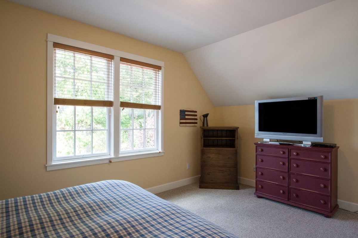 Second floor king bedroom with TV and view of the park