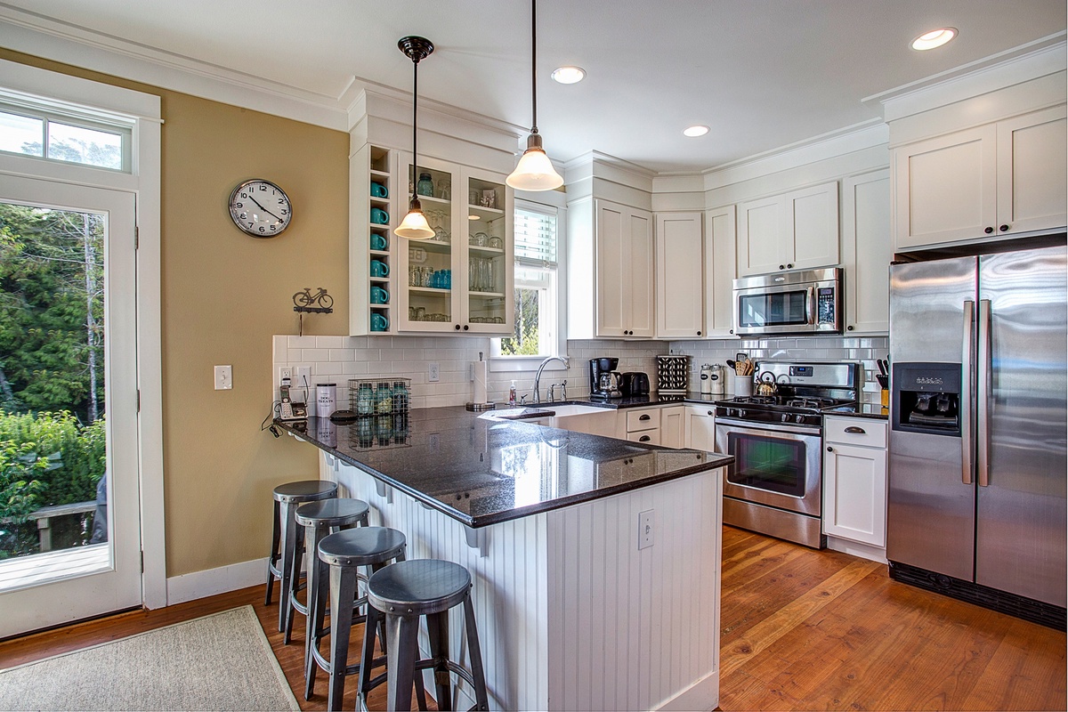 Full-stocked kitchen with stainless steel appliances and granite countertops