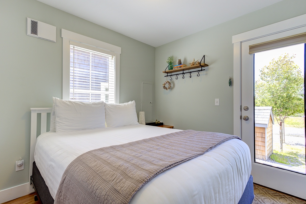 Main floor bedroom with door out to hot tub