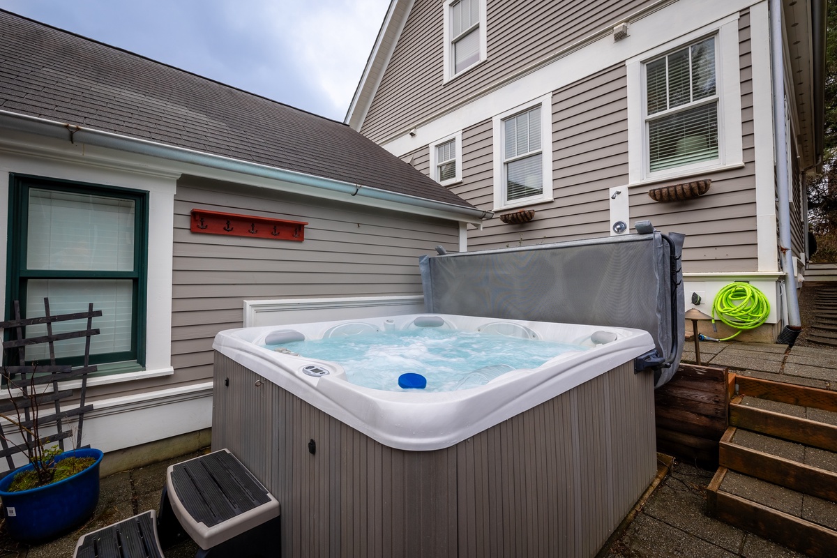Soak away a day at the beach in the private hot tub