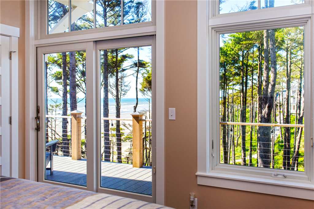 Private glass door to deck from main floor primary bedroom