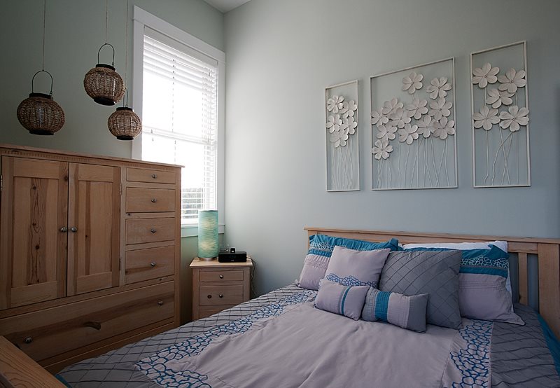 Second floor primary bedroom includes a comfy queen bed and soothing decor