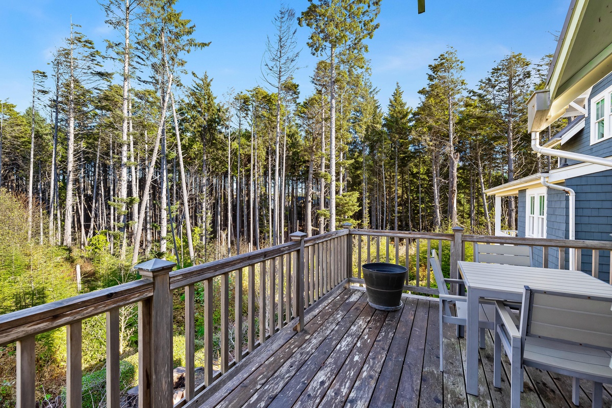 Deck with outdoor dining and forest views