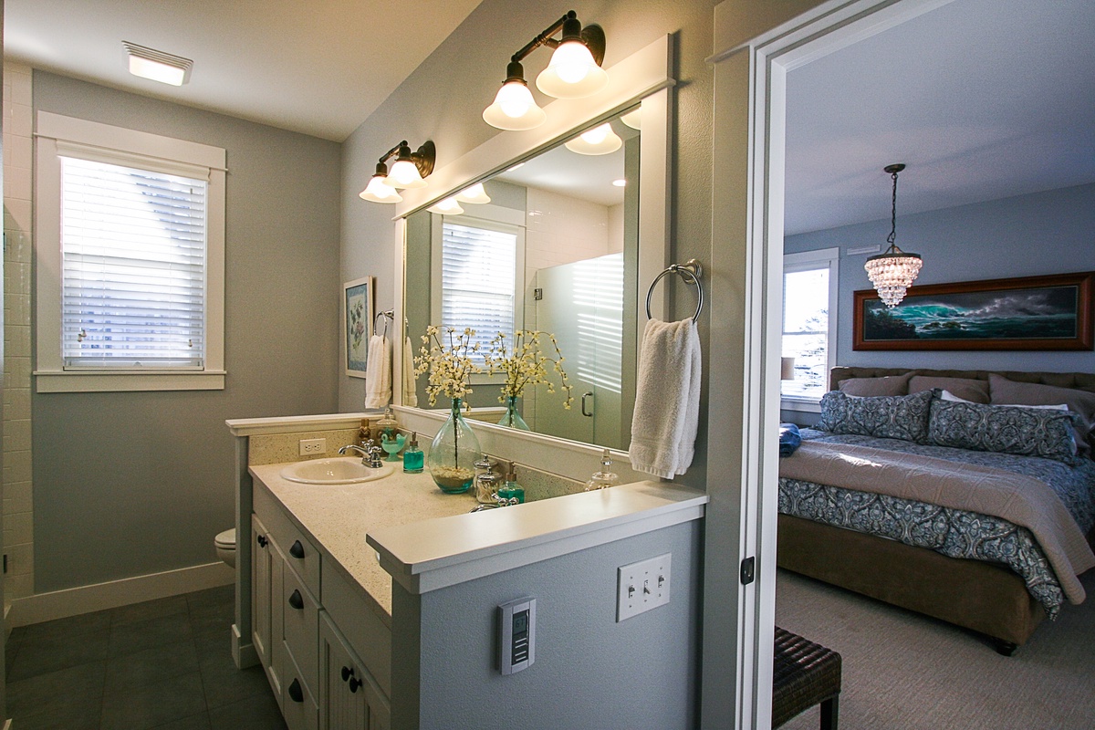 Primary ensuite bathroom with soaking tub, shower and walk in closet