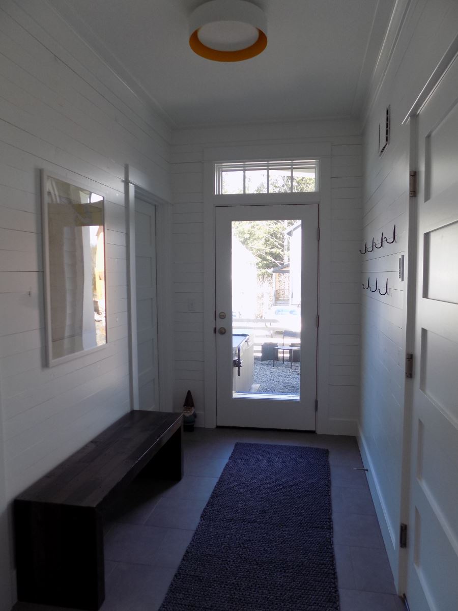 Hallway from the kitchen to the bathroom, and laundry room, and back entrance