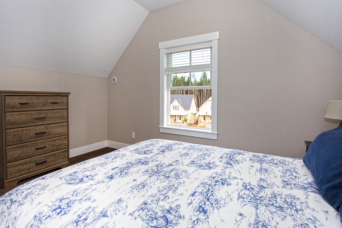 Third floor guest bedroom with queen bed and view of Horseshoe Park