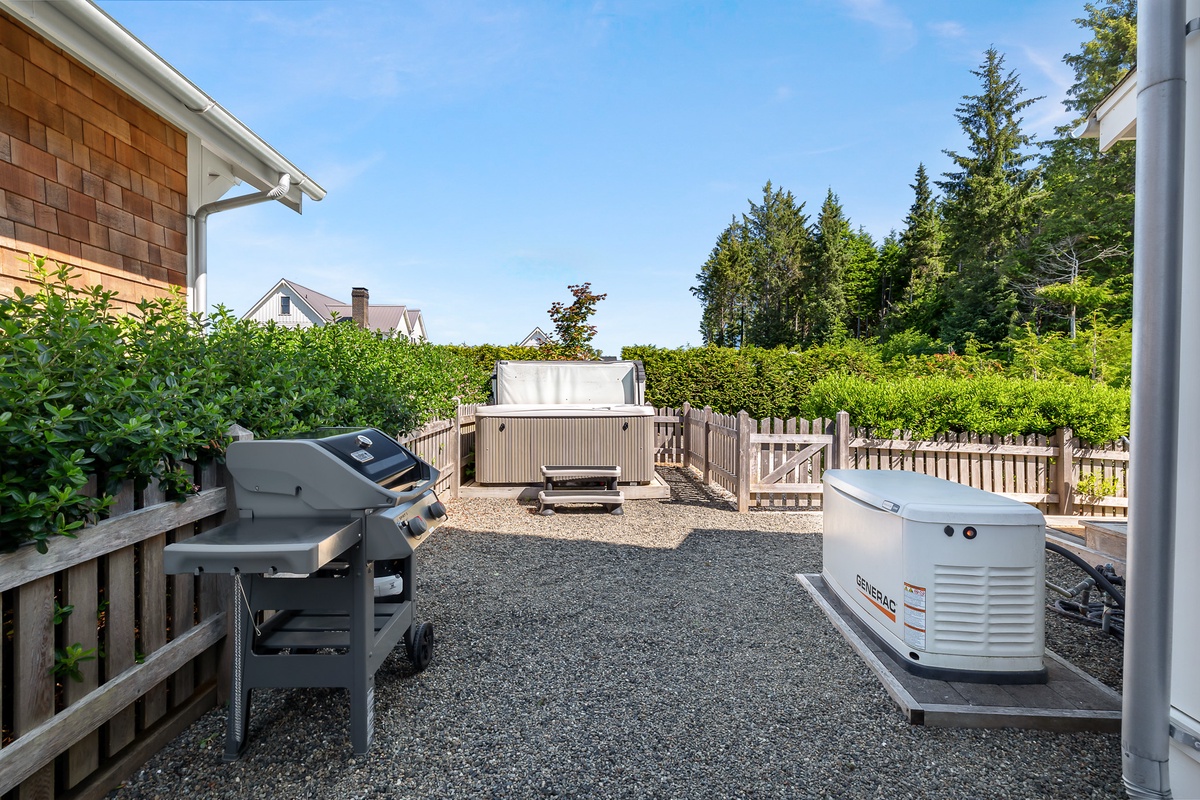 Back yard with hot tub, fire pit, and gas grill