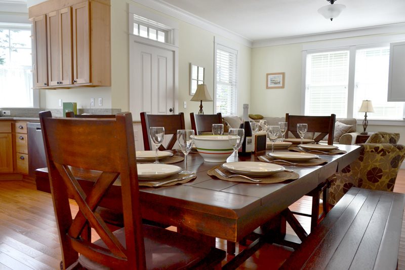 Sturdy wood trestle table in the dining area is large enough to comfortably seat 8 people