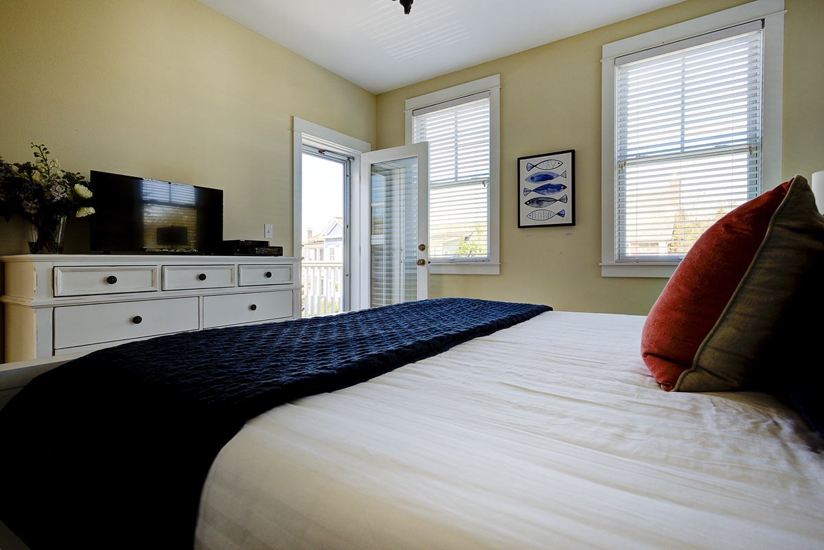 The primary bedroom has a deck and TV