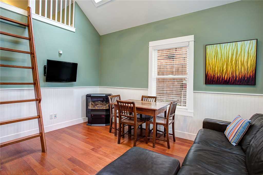 Dining & living room with fireplace and flat screen TV