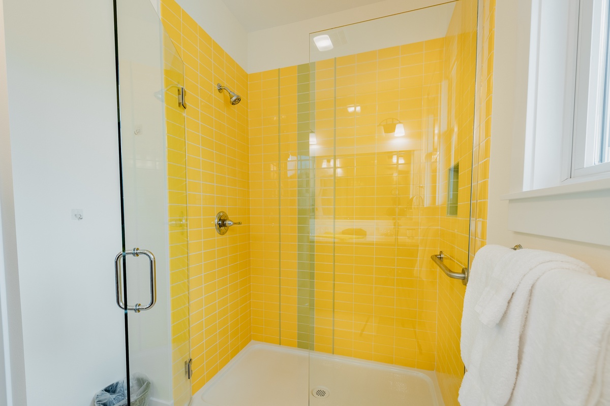 Enjoy the whimsically-tiled walk-in shower