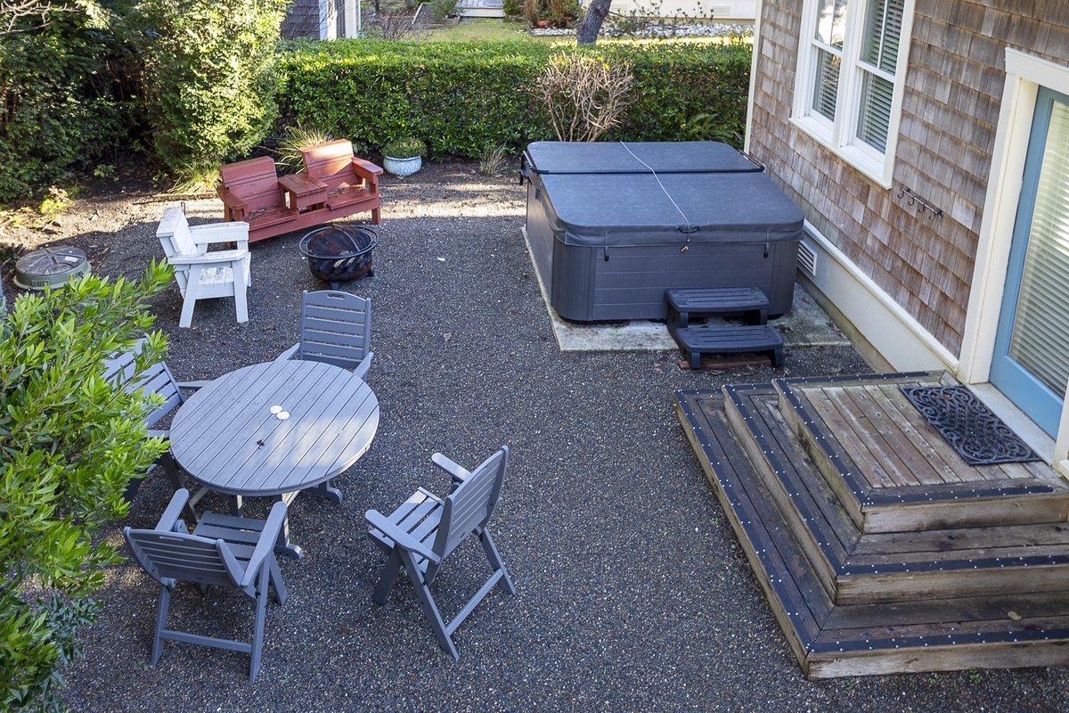 Backyard complete with firepit and hot tub