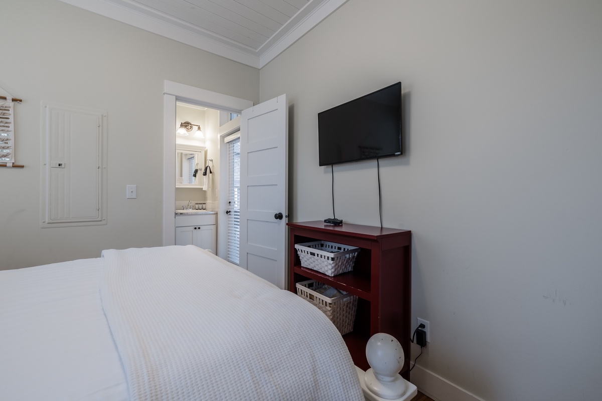 Primary bedroom with TV and ensuite bathroom