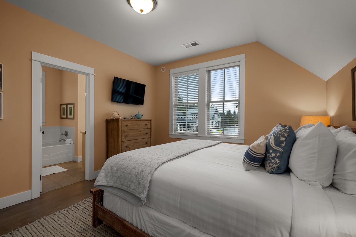 Second floor primary bedroom with ensuite bathroom and tv