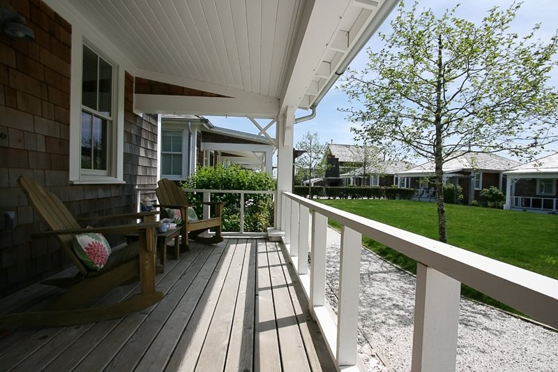 Front porch also overlooks a community courtyard with a fireplace, picnic table, charcoal grill, and bocce ball court