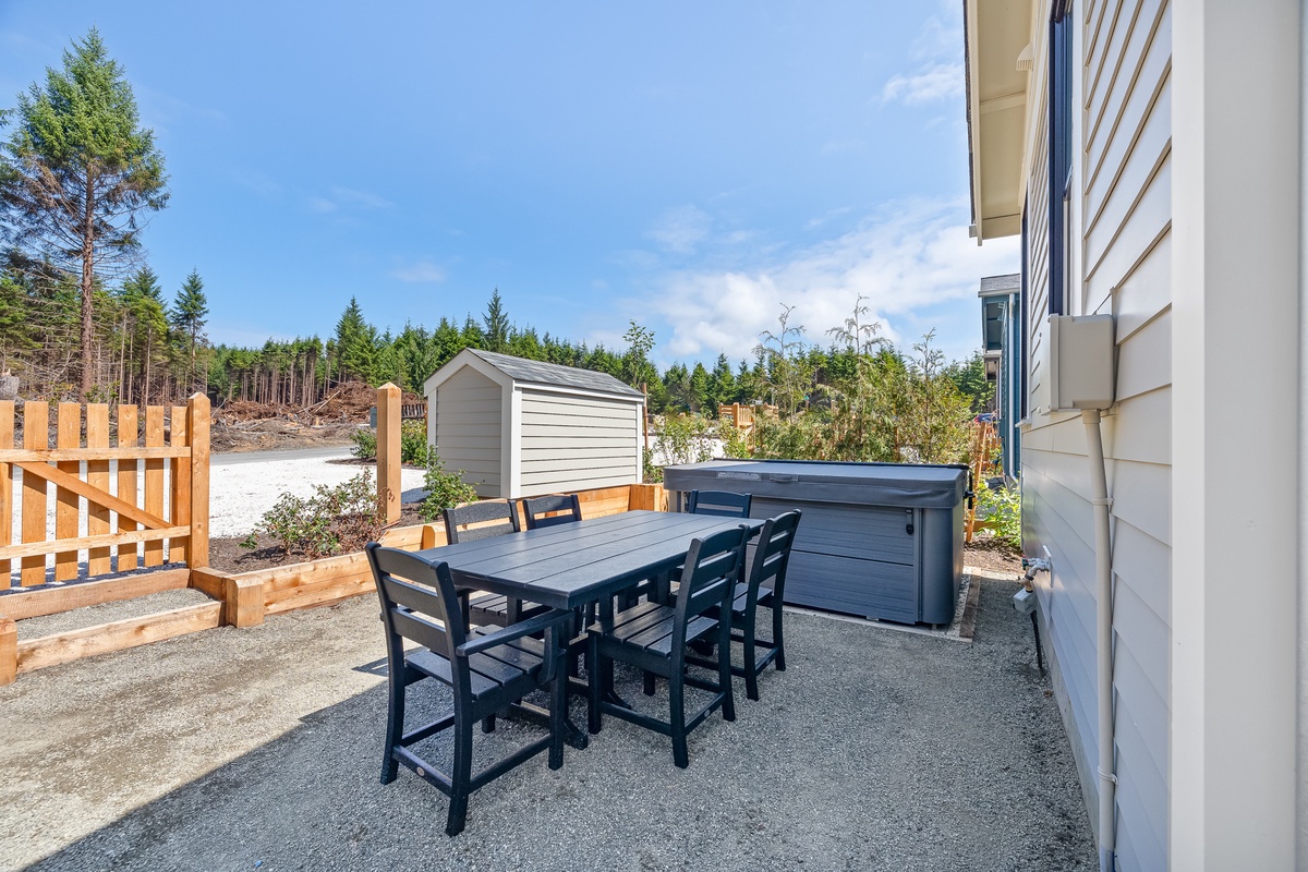 Backyard with hot tub and outdoor dining