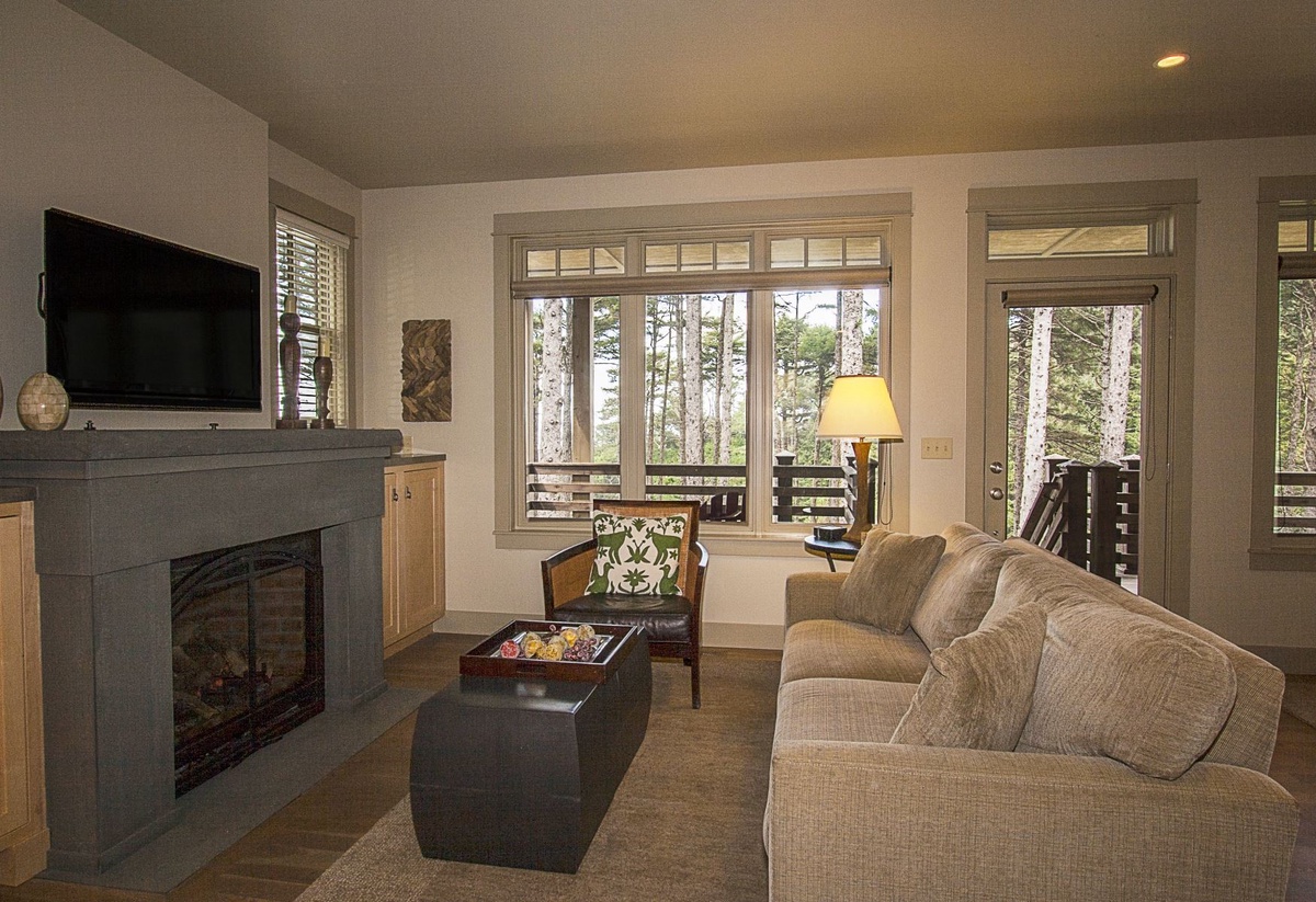 Main floor living room with ocean views, flat screen tv and gas fireplace