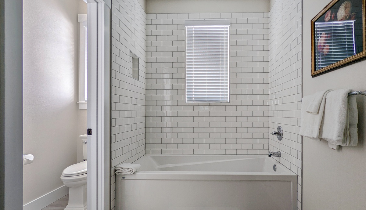 The ensuite bath has a tub and walk-in shower