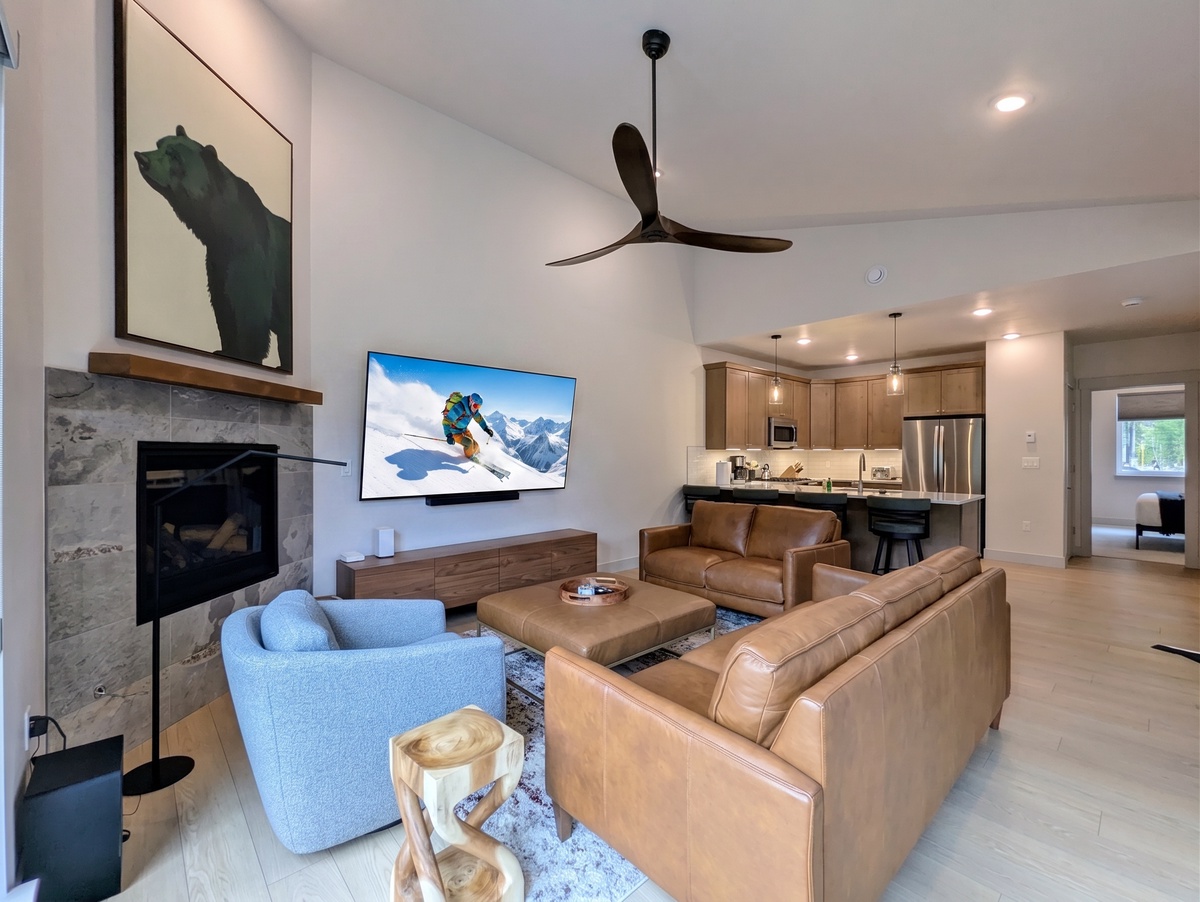 Relax in your spacious open-concept living area, where plush leather seating and a cozy fireplace invite you to unwind after a day of adventure.