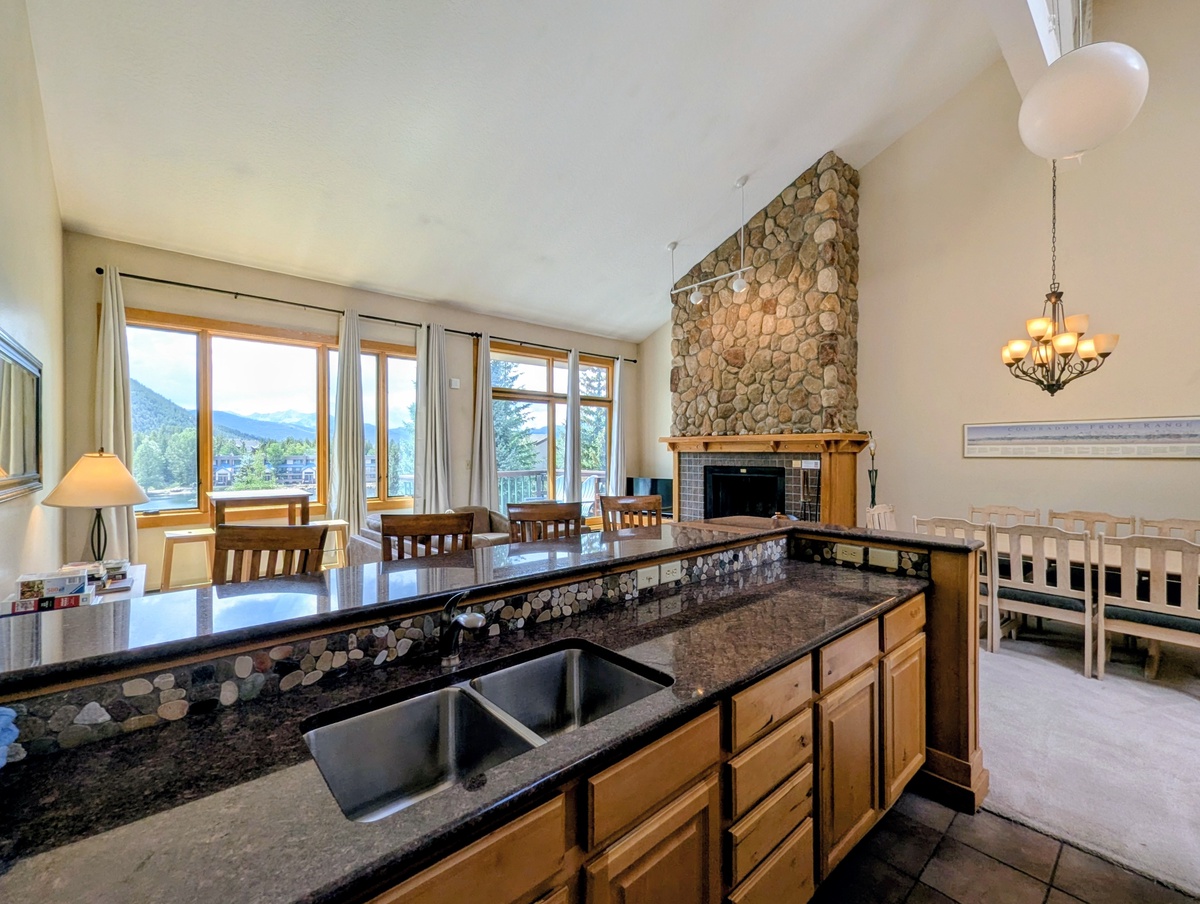 Mountain views and a cozy stone fireplace create your perfect retreat. Gather with loved ones in this bright, open space where rustic charm meets modern comfort.