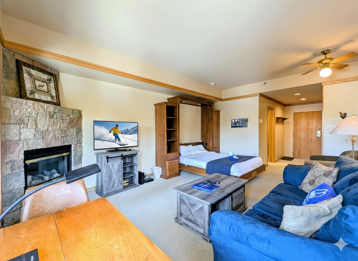 Your cozy retreat features a murphy bed, stone fireplace, and comfortable sectional—perfect for relaxing after mountain adventures.