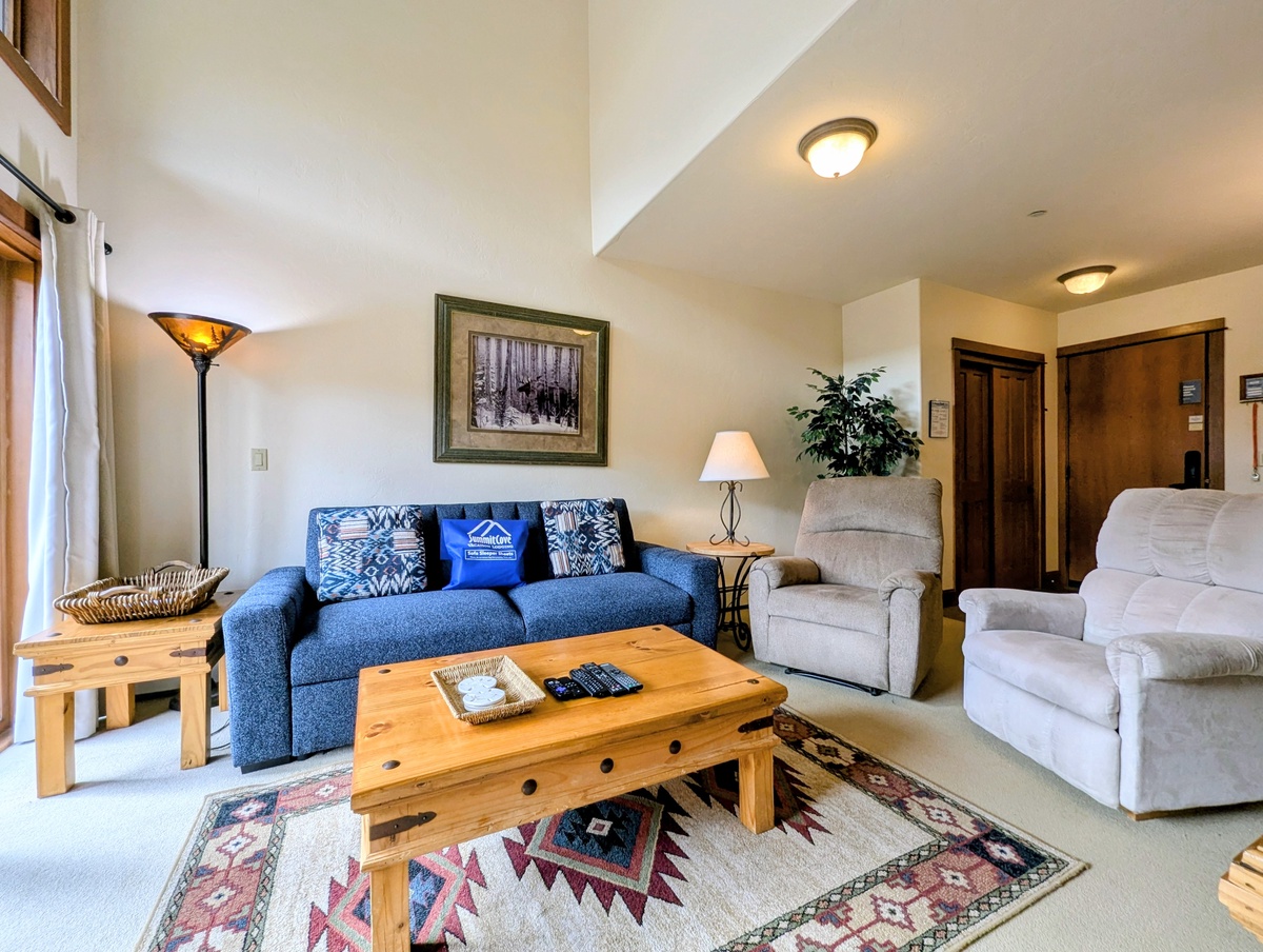 Settle into your inviting living area with cozy seating, warm wood accents, and thoughtful touches that make this space feel like home from the moment you arrive.