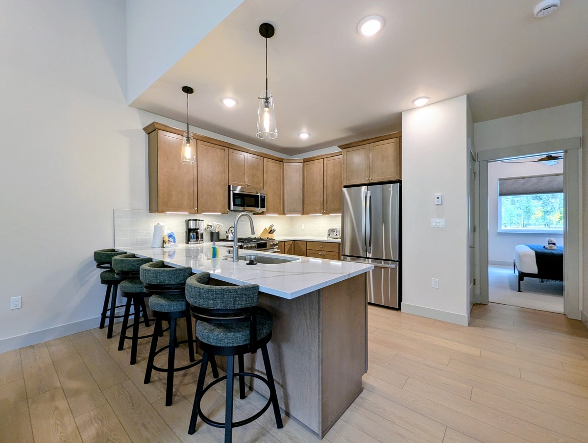 Step into your fully equipped kitchen with a spacious island where you can gather for breakfast or unwind with a glass of wine after a day of adventure.